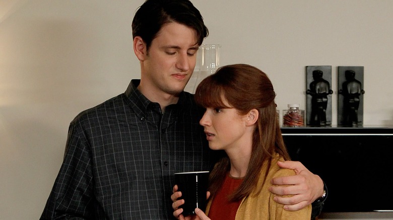 Zach Woods and Ellie Kemper as Gabe and Erin, hugging awkwardly at his party on The Office