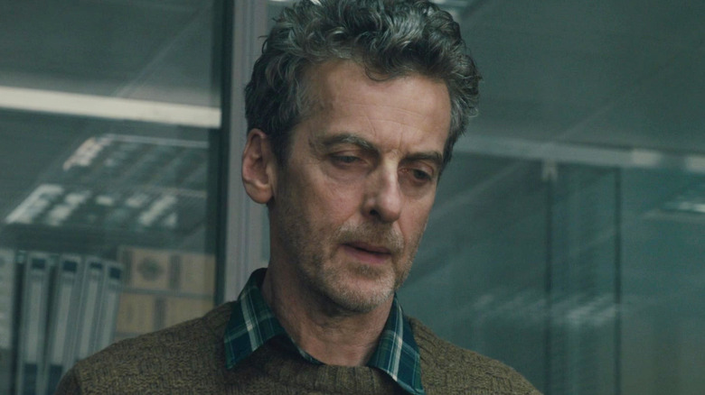 Peter Capaldi as a WHO doctor looking downtrodden in World War Z