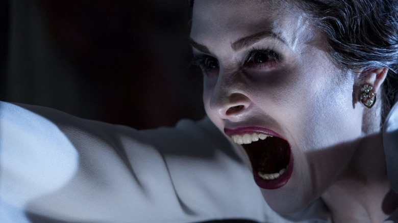 Ghost Michelle howls in horror as she haunts the Lamberts in Insidious: Chapter 2