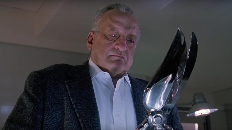 Kinderman inspects a set of shears in The Exorcist III